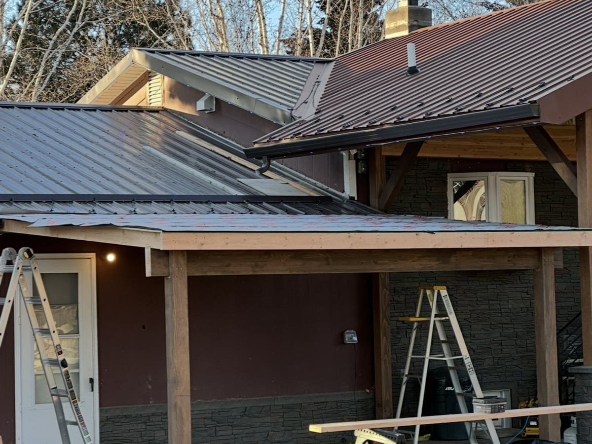 Custom home with metal roof and stone column accents in Western Montana